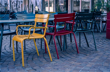 Red and yellow empty chairs of a closed restaurant during the coronavirus lockdown in Zurich