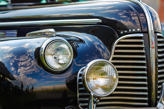 Minsk, Belarus - May 07, 2016: Close-up photo of black Buick Eight 1940 model year. Fragment of old vintage car. Headlights of retro auto. Selective focus.