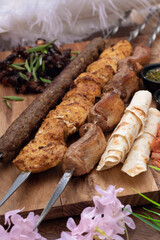 Beef shashlik on a woosen board. Marinated meat for lunch
