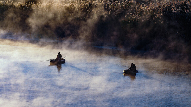 Fishermen at dawn on the Volga river, Russia.