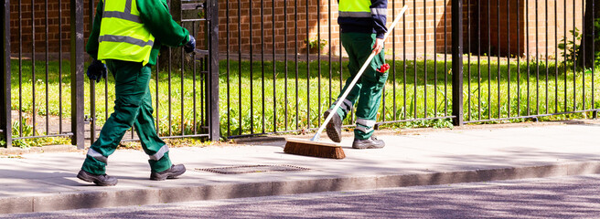 Street cleaners walking along in Hackney, London