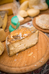 Heads of cheese. Hard cheese. Cheese. Cheese Festival. Craft cheese. A piece of hard cheese. 