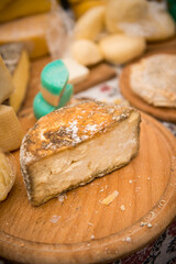Heads of cheese. Hard cheese. Cheese. Cheese Festival. Craft cheese. A piece of hard cheese. 