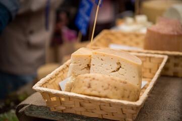 Heads of cheese. Hard cheese. Cheese. Cheese Festival. Craft cheese. A piece of hard cheese. 