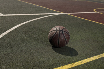 
basketball ball on a green playground in the yard