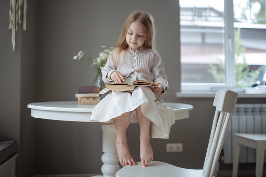 blond girl with long hair reading