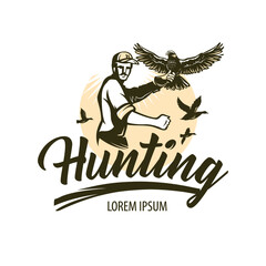 Man practicing hunting with falcons. Hawk with spread wings sits on the hunter's hand. Predator species with broad wings, sharp beaks and claws.