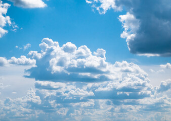 Large white clouds with a flat bottom floating in a bright blue sky