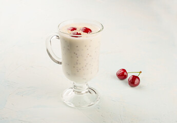 Chia yogurt pudding with coconut flakes and cherry berries. Copy space.