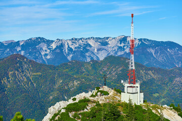 Antenna and cell phone towers on a mountaintop on a clear day in autumn.