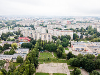 Fototapeta na wymiar Aerial view of town with socialist soviet panel building at cloudy day. Buildings were built in the Soviet Union now Ukraine. The architecture looks like most post-soviet commuter towns.