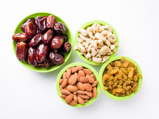 khajur, raisin/kismis, kaju badam/ cashew and almonds all at a single frame stock image white background.
