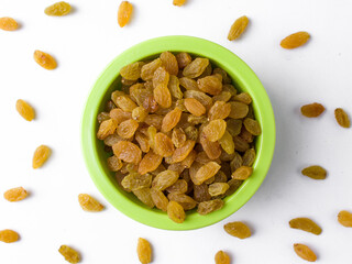 Fresh raisin in a green bowl with a white background. 
