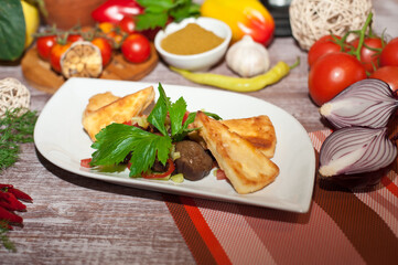 Fried eggplant and cheese with herbs on a white plate . Healthy diet