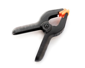 black plastic clip on a white background. repair tool. Top view