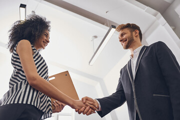 Two smiling business people greeting each other