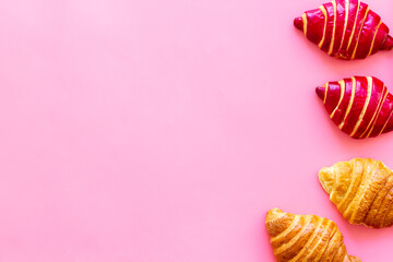Set of croissants - berry, classic - on pink background top view