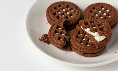 Macro photo of chocolate cookies with filling on a white background. Isolate, close up