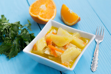 Celery salad with orange on blue background.