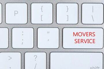 Modern computer keyboard with phrase MOVERS SERVICE, closeup