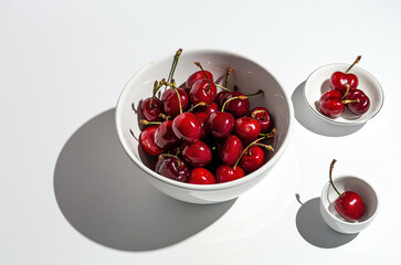Fresh seasonal red cherries in strong sunlight