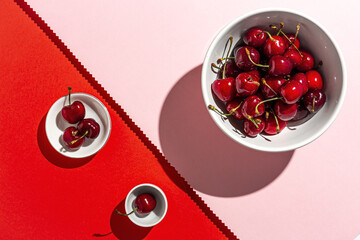 Fresh seasonal red cherries in strong sunlight
