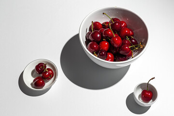 Fresh seasonal red cherries in strong sunlight