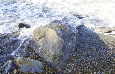Waves breaking on stones, seashore