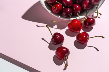 Fresh seasonal red cherries in strong sunlight
