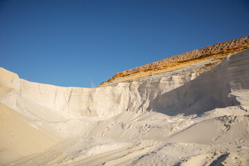 White sand and blue sky. Embossed sand mountains of white sands. Desert landscape. 