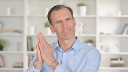 Fototapeta premium Portrait of Cheerful Middle Aged Businessman Clapping
