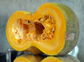 Sliced half pumpkin with seeds close-up