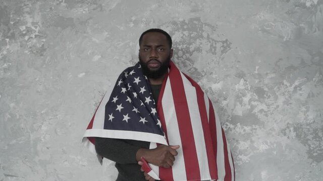 black activist, African American protests with the American flag. Looking at camera