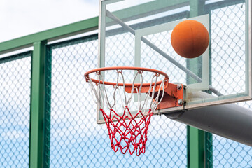 Basketball ring with a net and ball, sport
