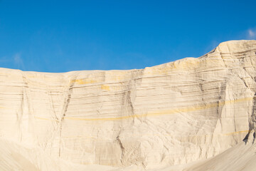 White sand and blue sky. Embossed sand mountains of white sands. Desert landscape. 