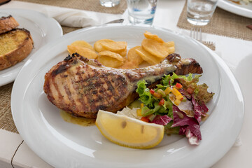 Chop with salad potatoes and lemon