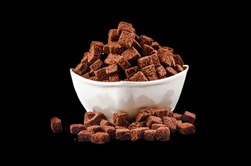 Chocolate and coffee beans on black background