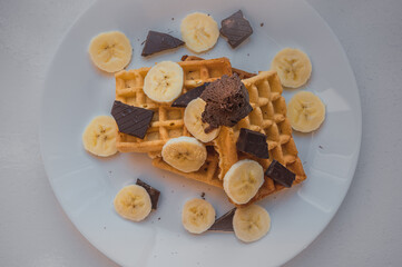 Waffle breakfast with banana and chocolate ice cream