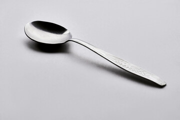 Isolate metallic spoon in Grey background