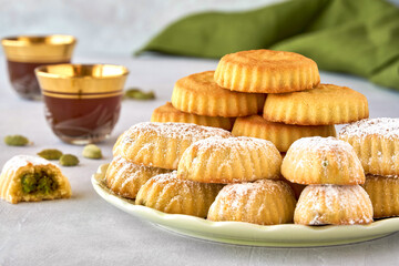Traditional arabic eid sweets. Maamoul or mamoul cookies with pistachios and dates . Close up
