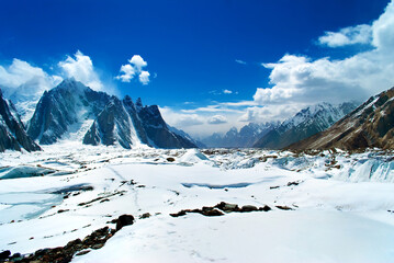 Snow peaks of mountains with blue sky and beautiful clouds. Winter tourism in Karakorum, Pakistan....