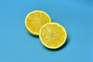 Fototapeta na wymiar beautiful sliced lemons on a blue background yellow