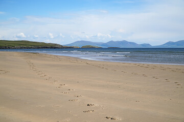 Footprints in the sand on a deserted beach at Aberffraw, Anglesey, Wales, UK