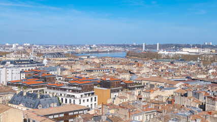 Fototapeta premium Bordeaux, beautiful french city, typical tiles roofs in the center, with the Garonne river in background 