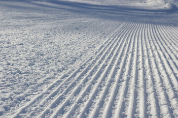Snow texture with traces of ratrac machine