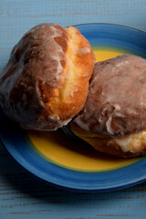 two sweet donuts and two cups of orange juice