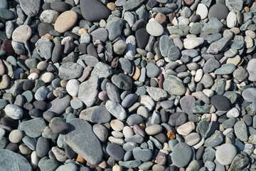 Close up of pebbels on a beach forming and abstract pattern
