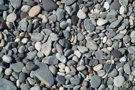Close up of pebbels on a beach forming and abstract pattern