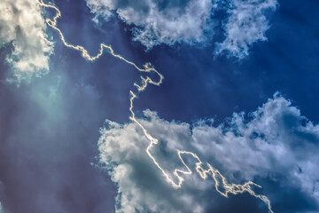 Lightning sparkles in the dark sky with cumulonimbus clouds. Tropical storm. Mystical natural phenomenon.