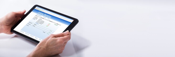 Person Using Online Banking Service On Digital Tablet